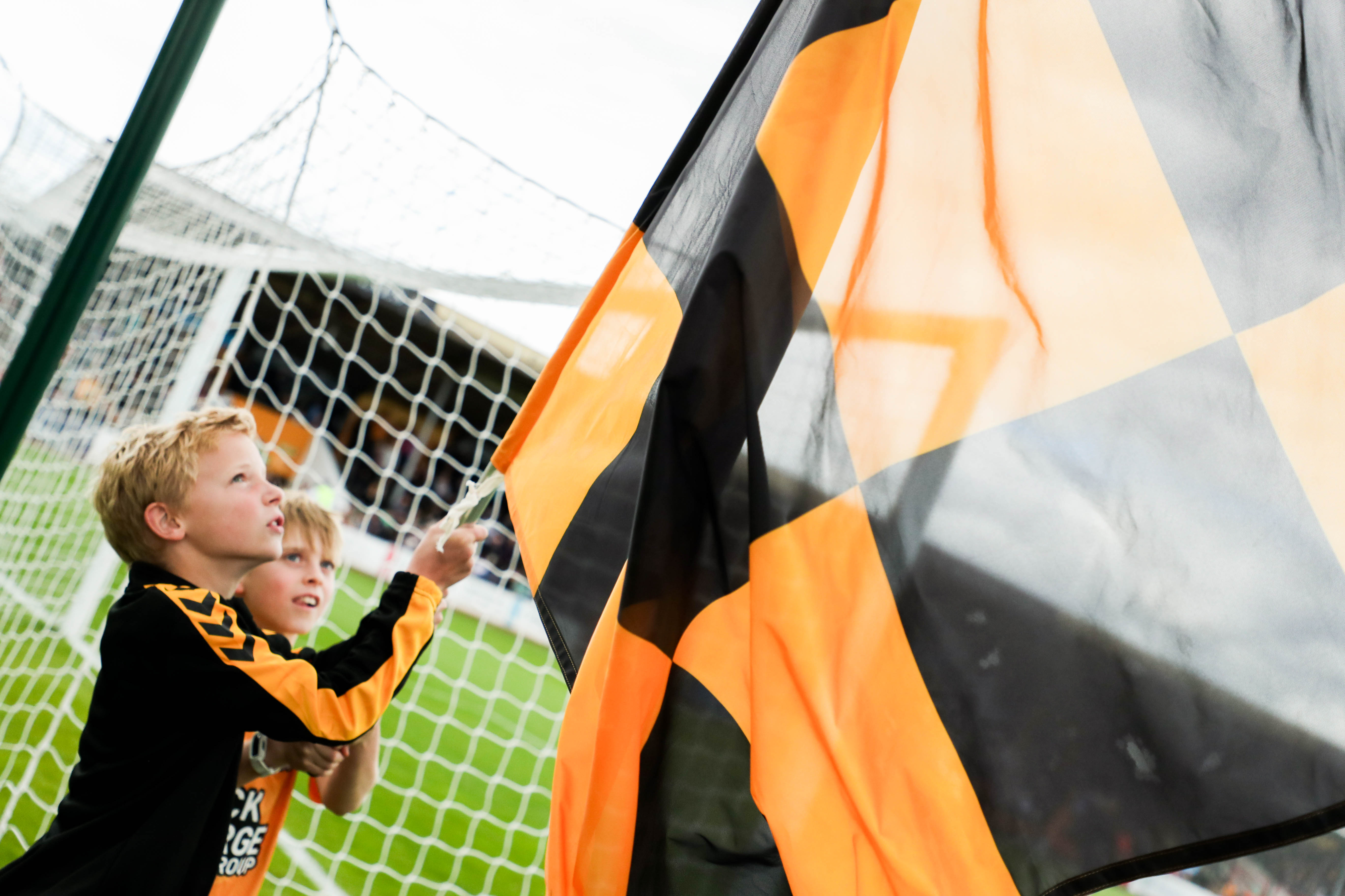 A young fan hoisting a flag ahead of kick-off