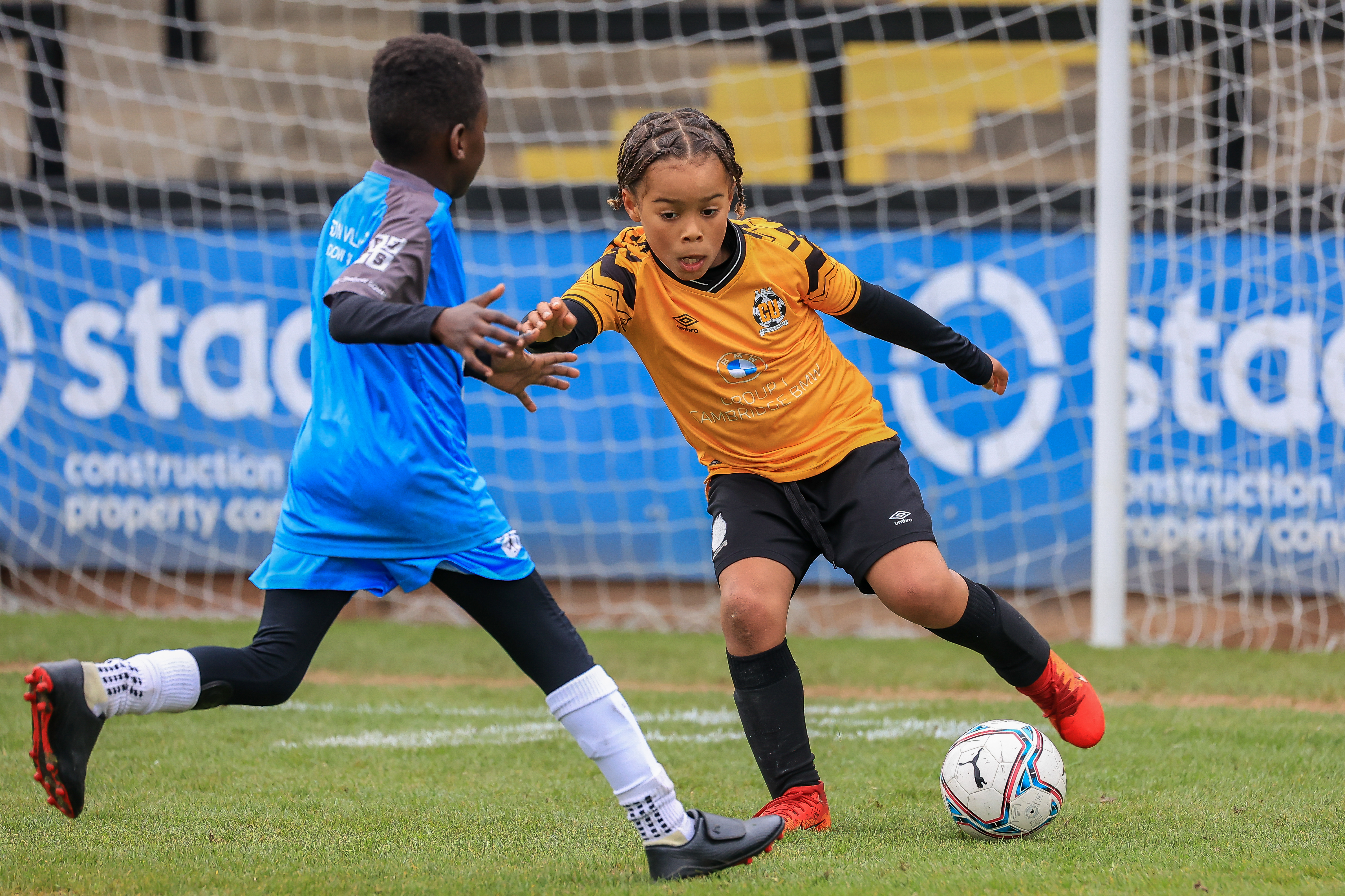 A Cambridge United Academy player takes on his opposition
