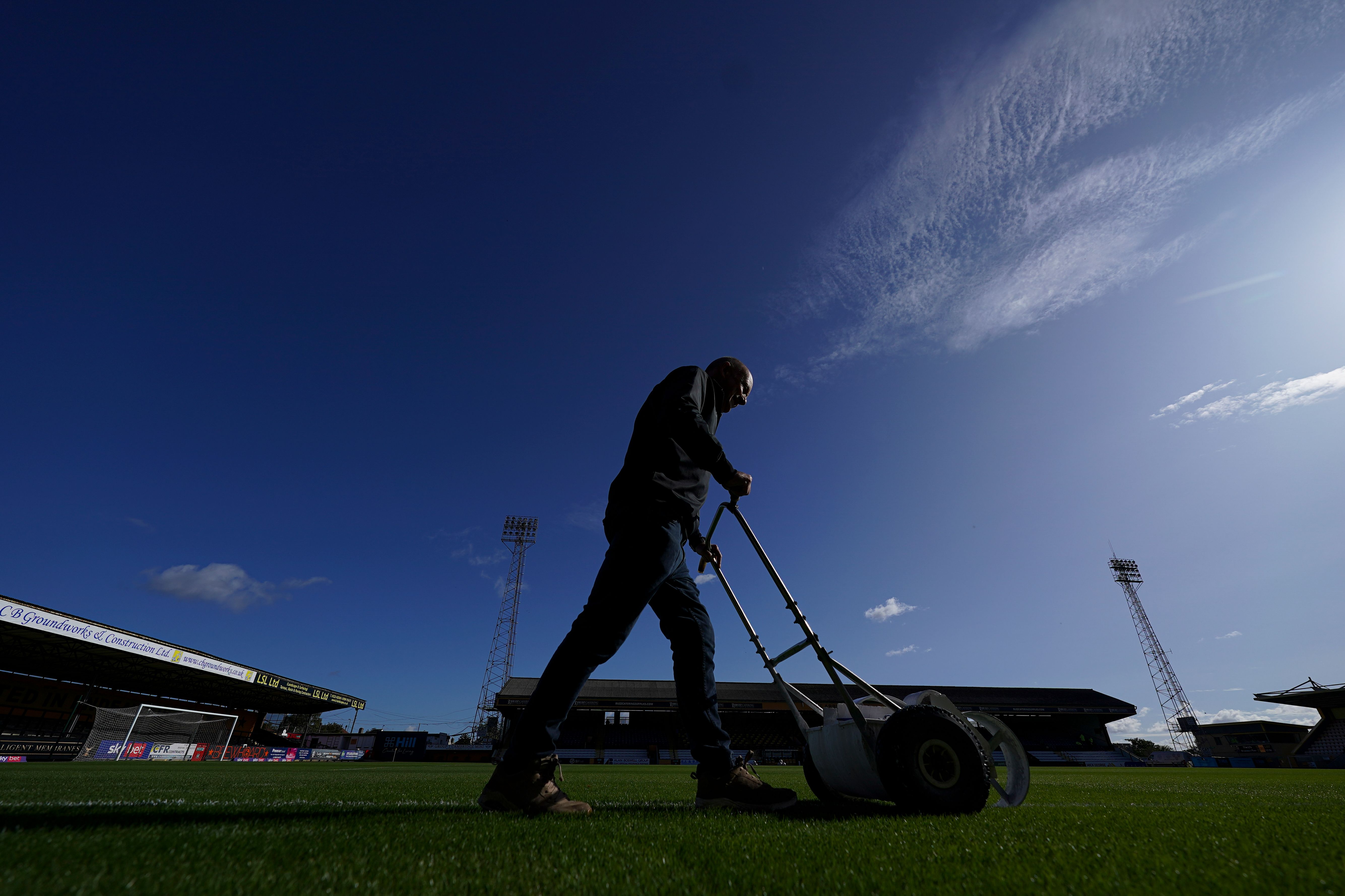 Ian Darler cuts the grass at the Cledara Abbey Stadium