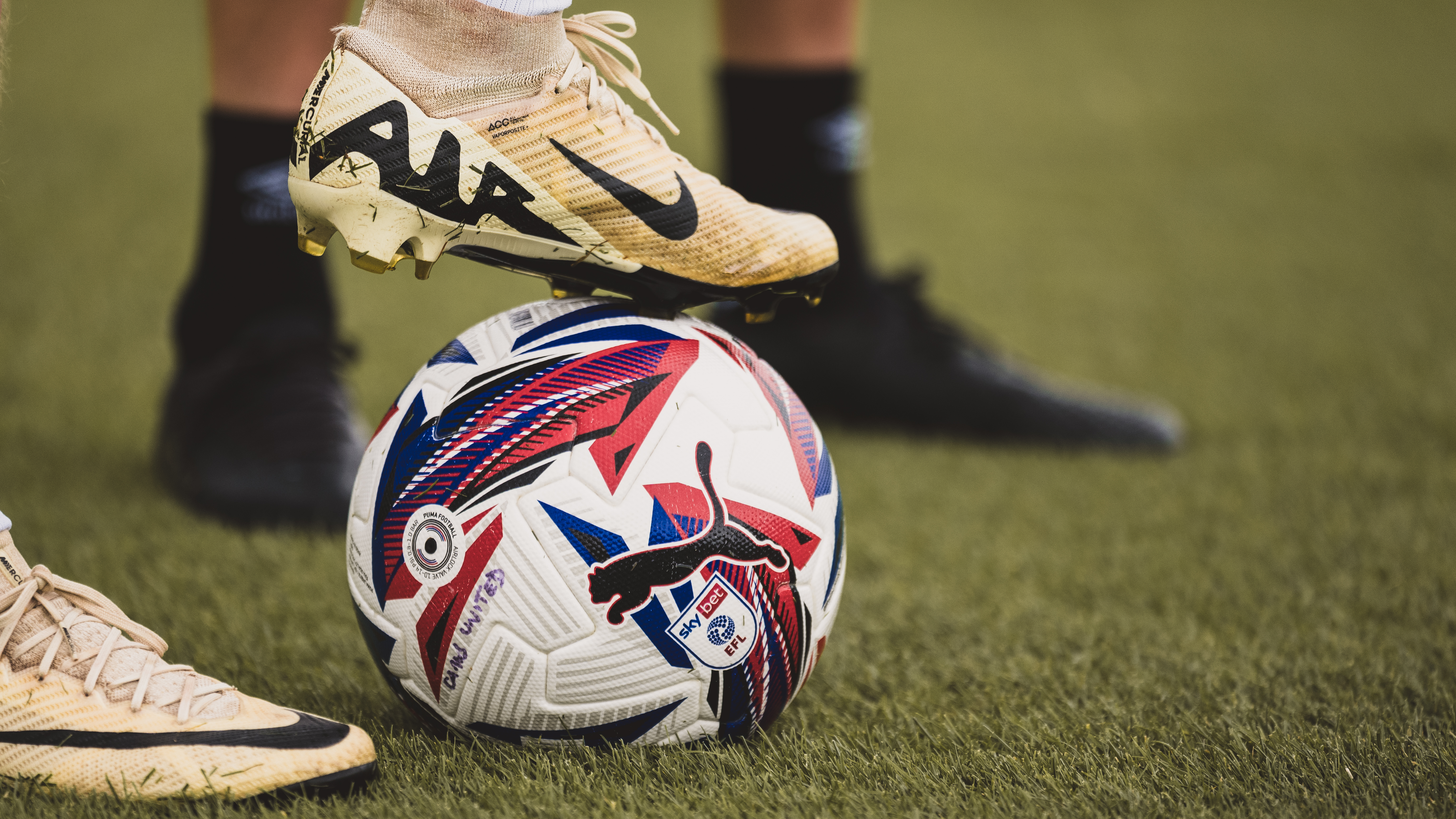 A close up of a player with the ball under his feet