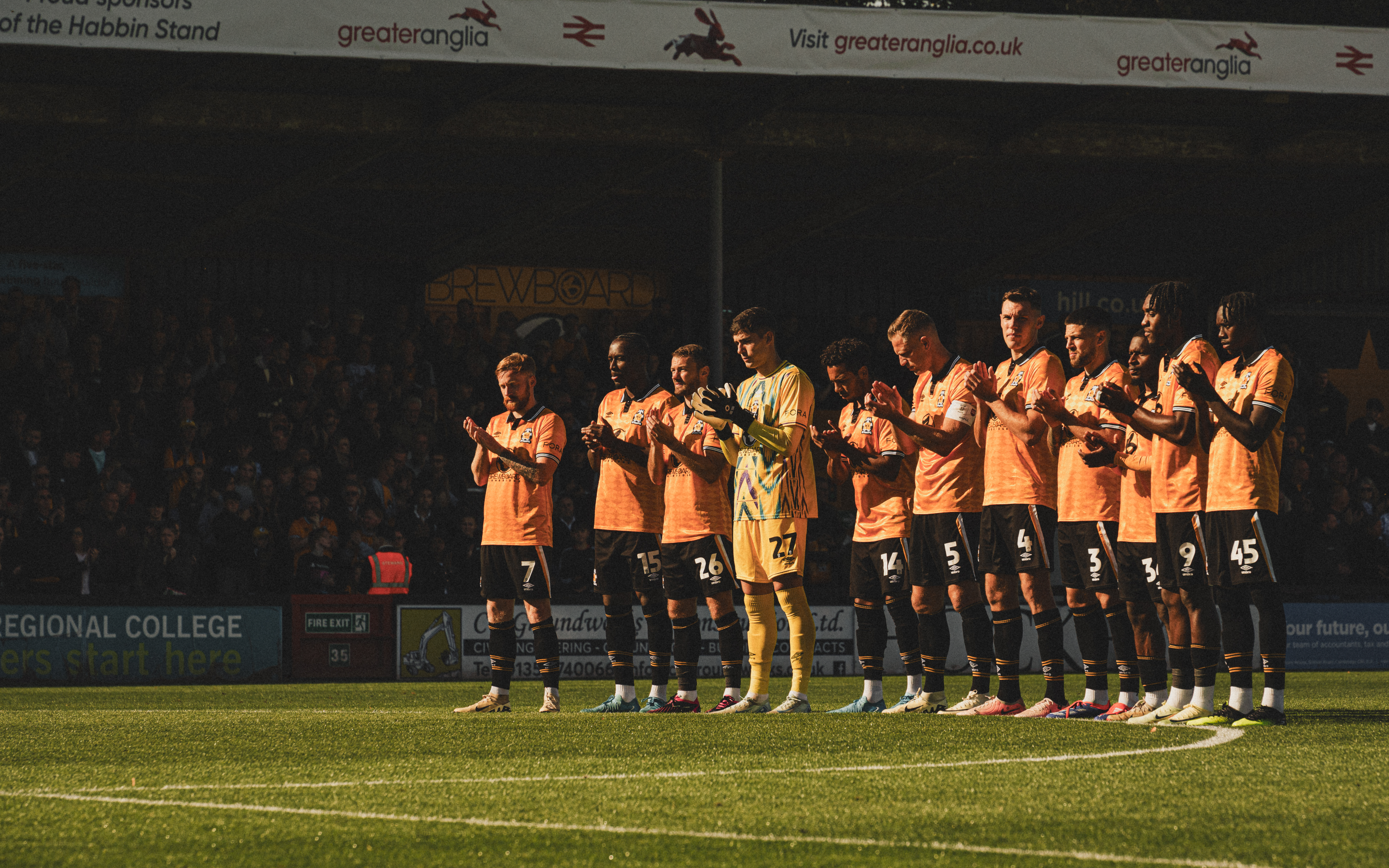 Players take part in a pre-match tribute