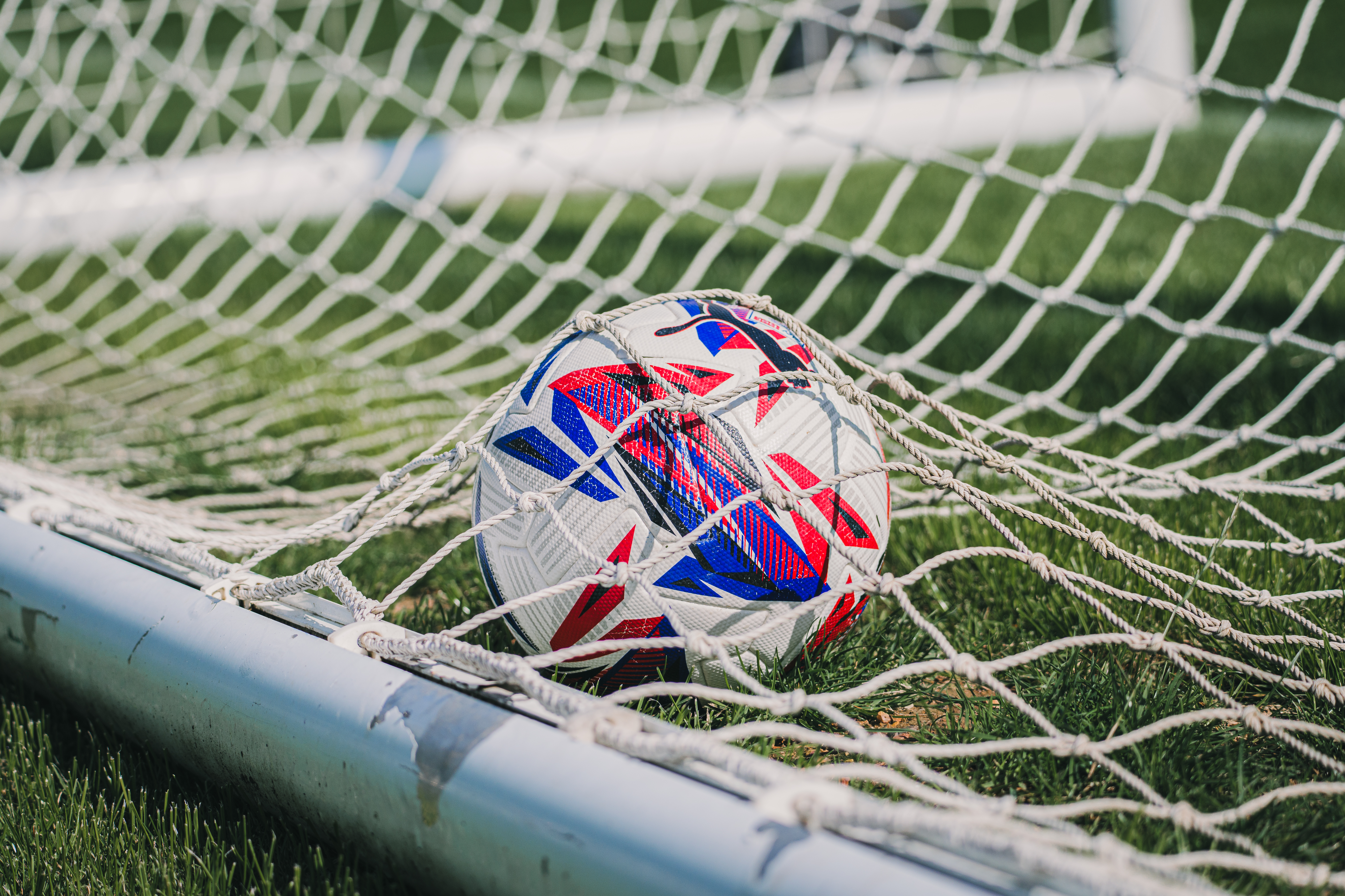 A close-up of a ball in the goal