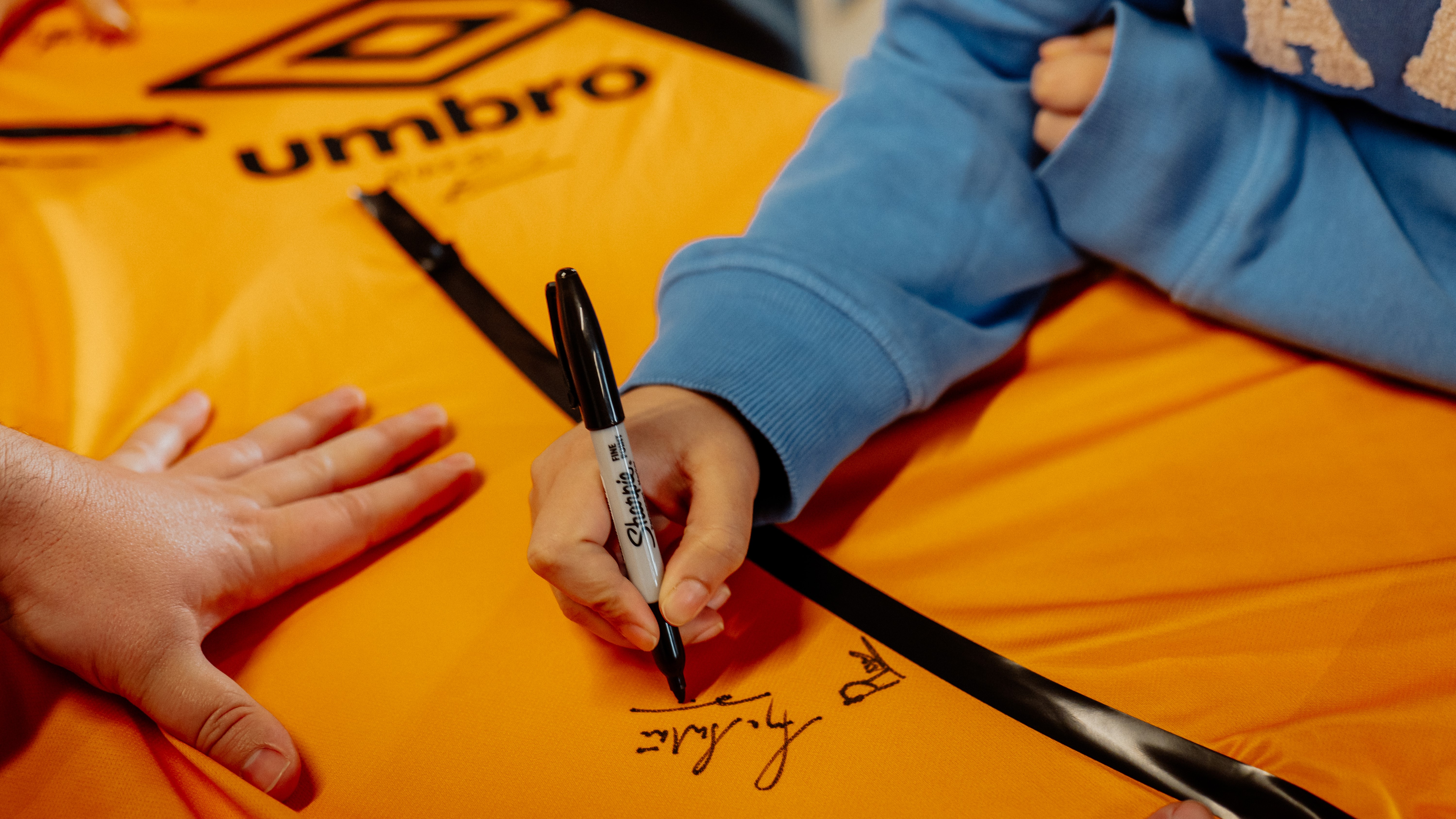 A close up of a shirt being signed