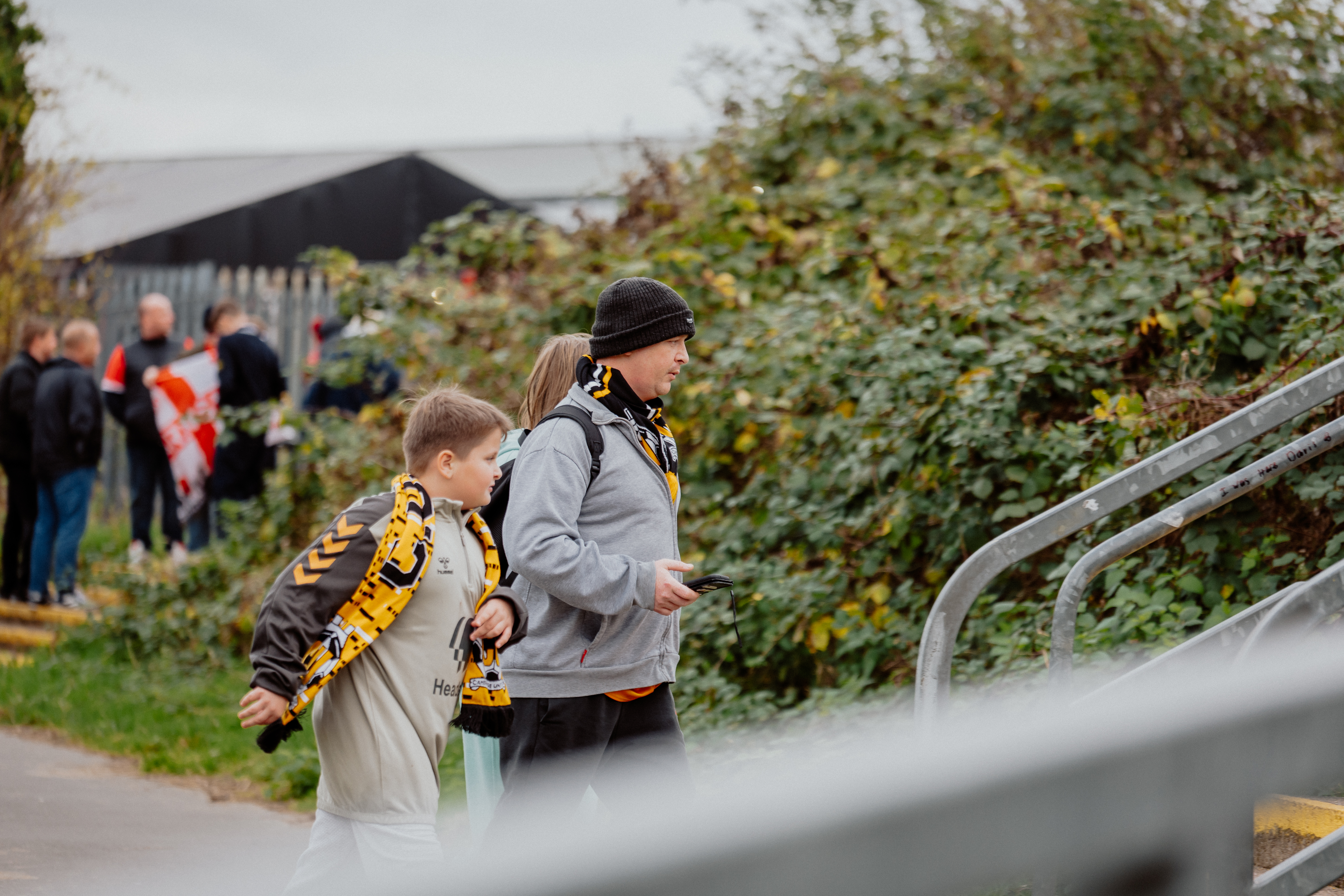 A father and son walk up to the Cledara Abbey Stadium