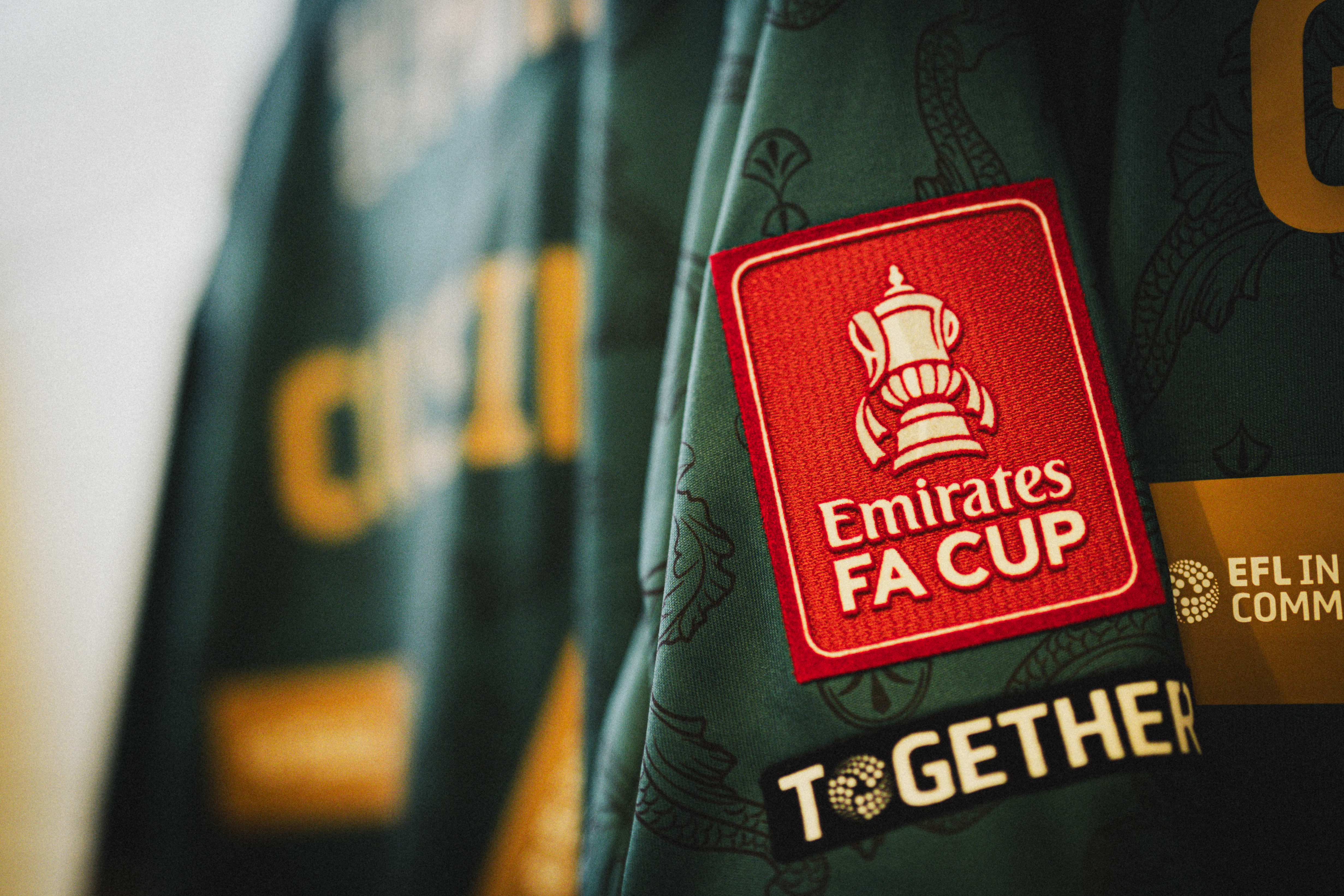 A close up of the Emirates FA Cup badge on a Cambridge United shirt