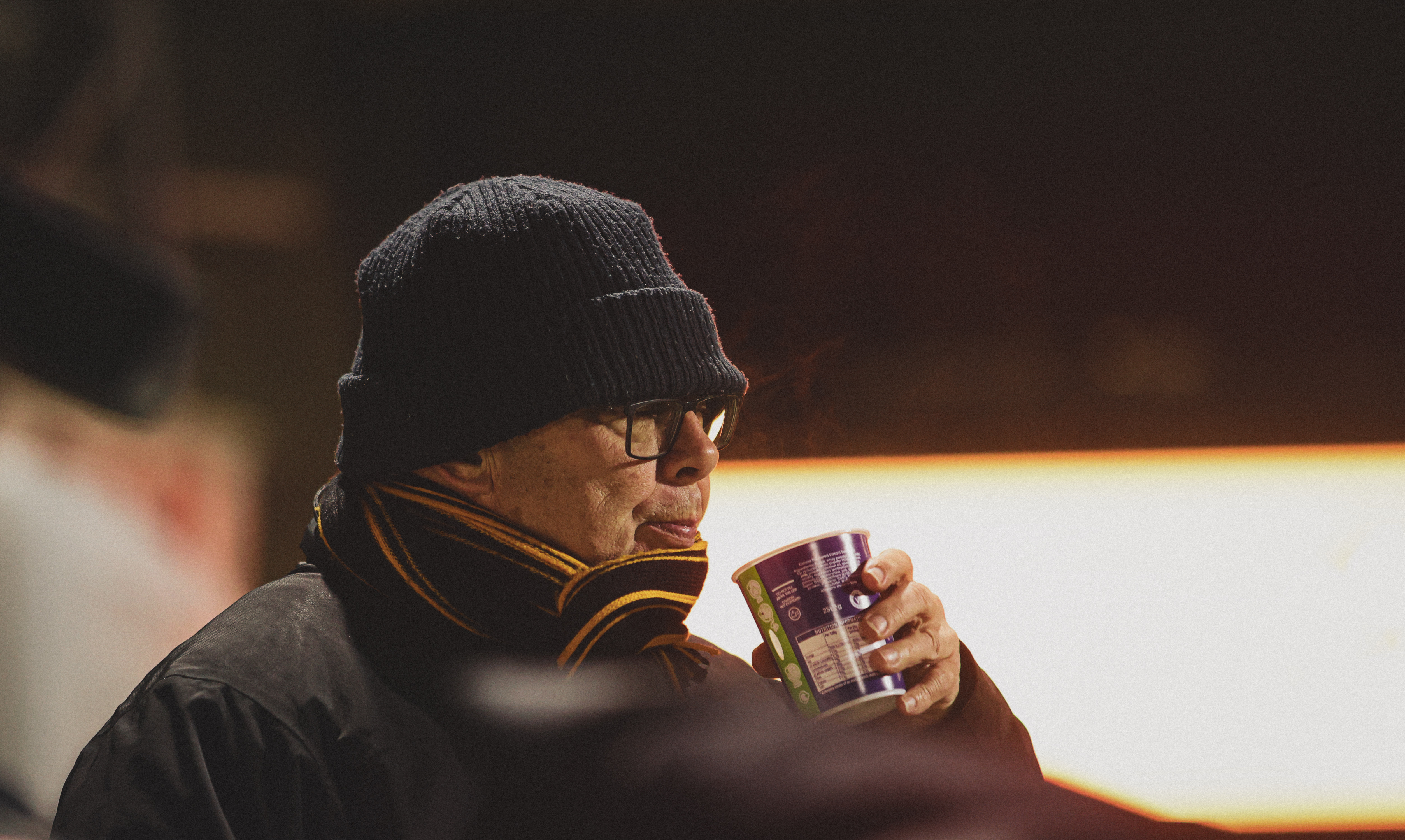 A Cambridge United supporter at an evening game