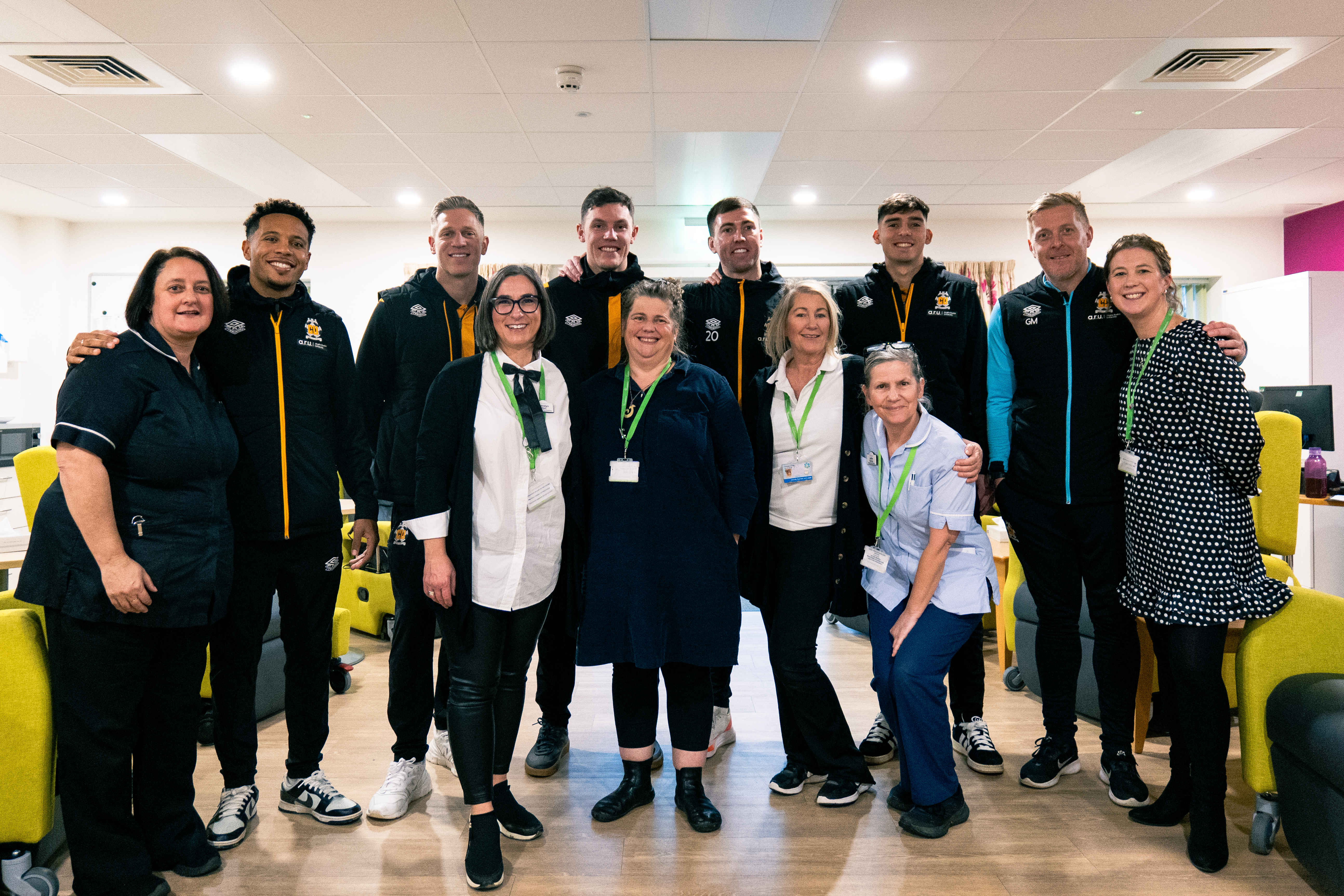 Cambridge United players with Arthur Rank Hospice staff