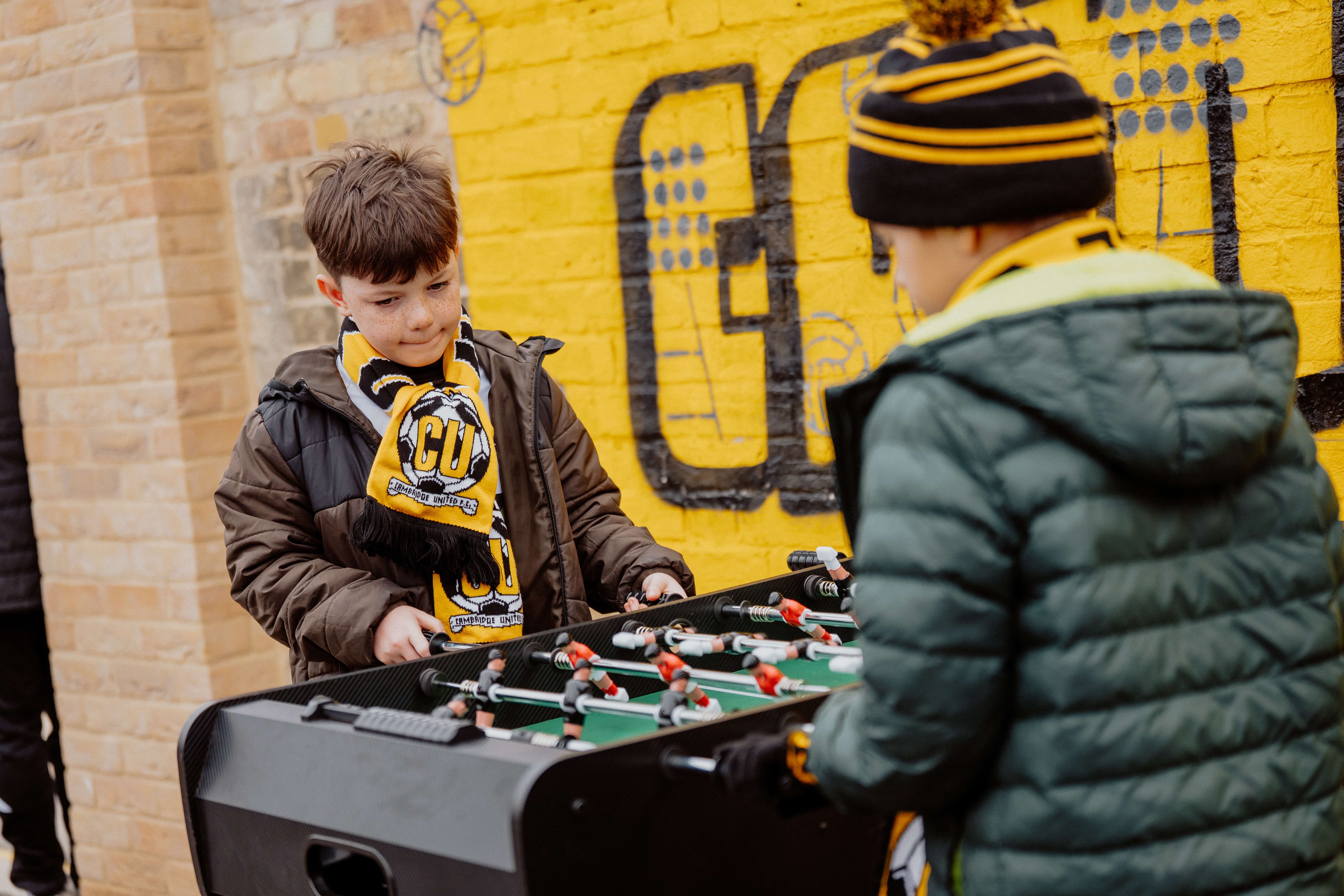 Young supporters playing Table Football at the Cledara Abbey Stadium