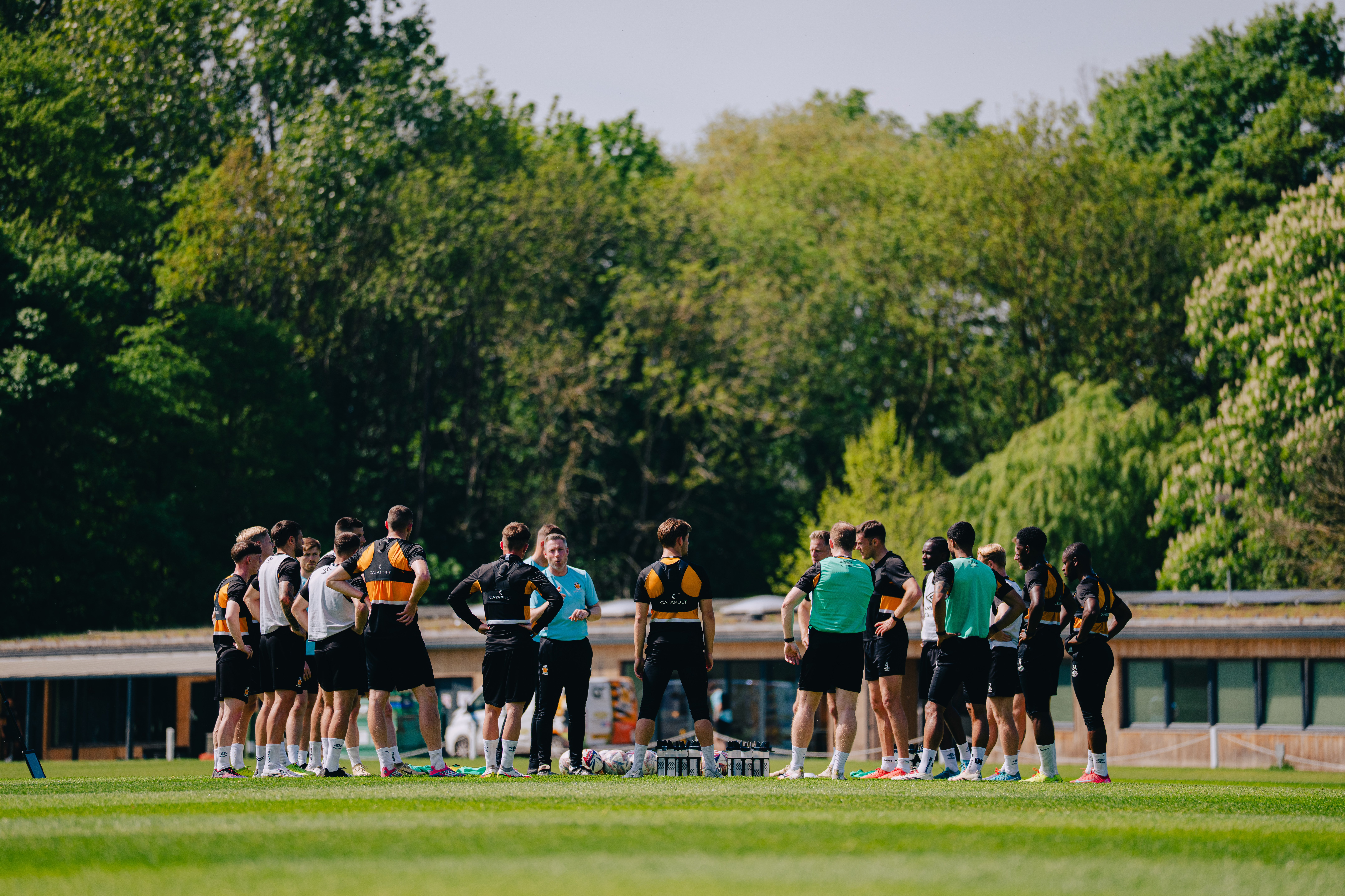 Neil Harris addresses the players in training