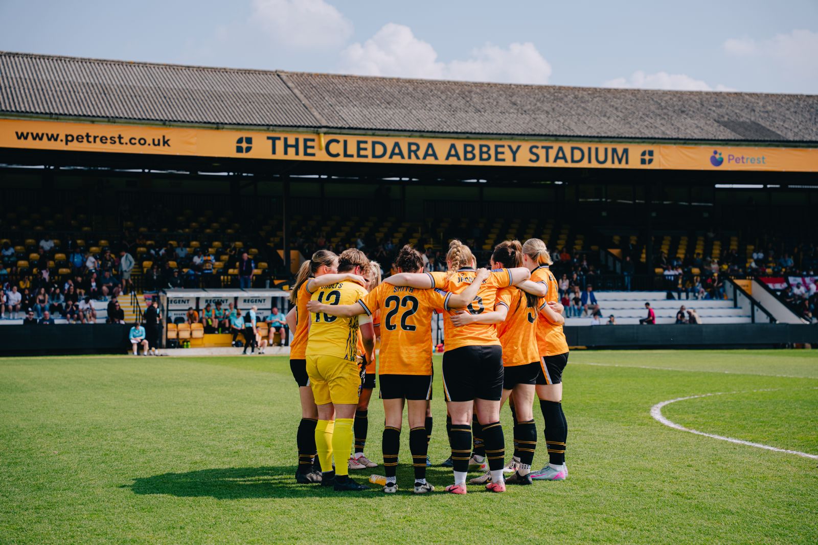 Cambridge United Women's player huddle at the Cledara Abbey Stadium