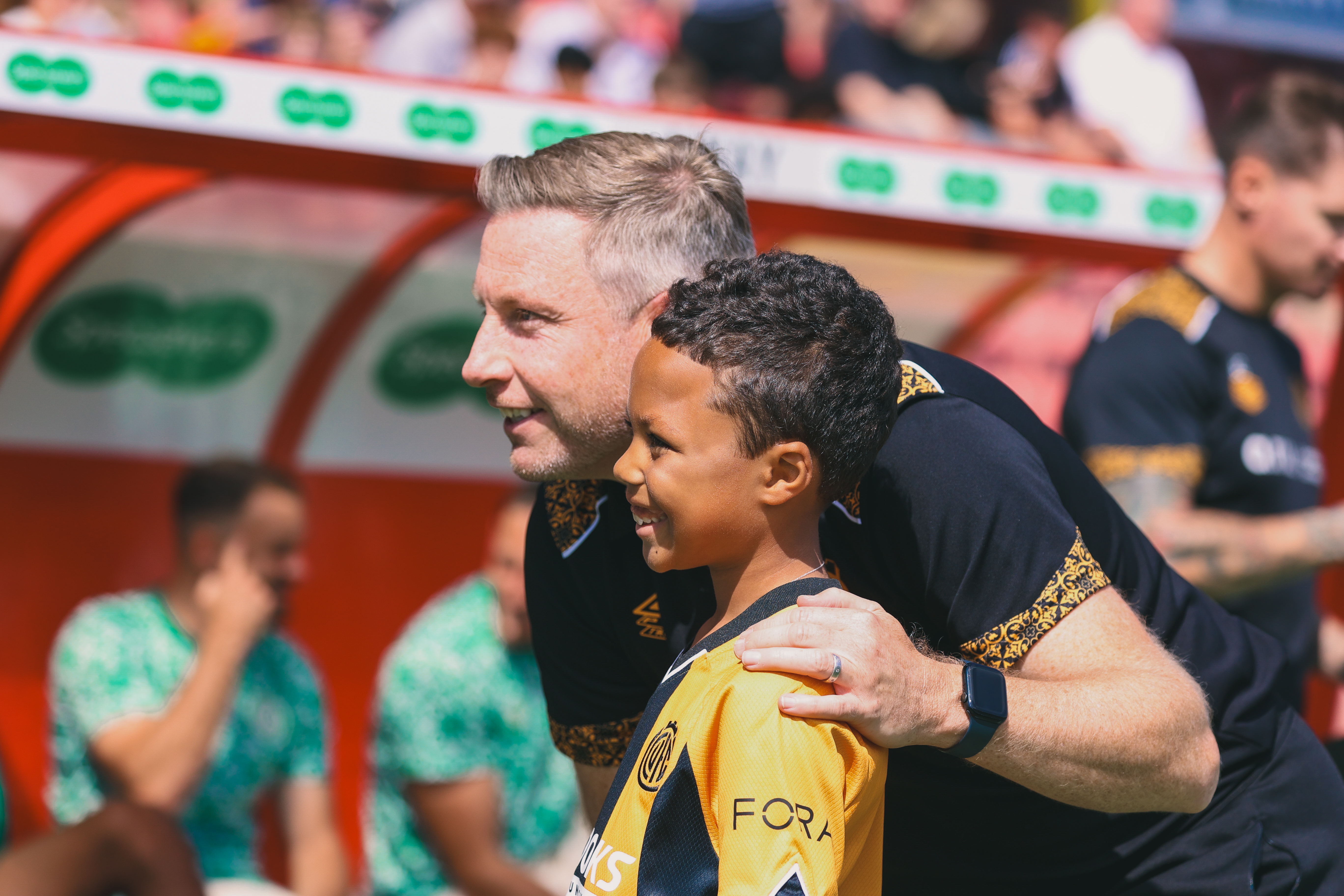 A young fan poses with Neil Harris