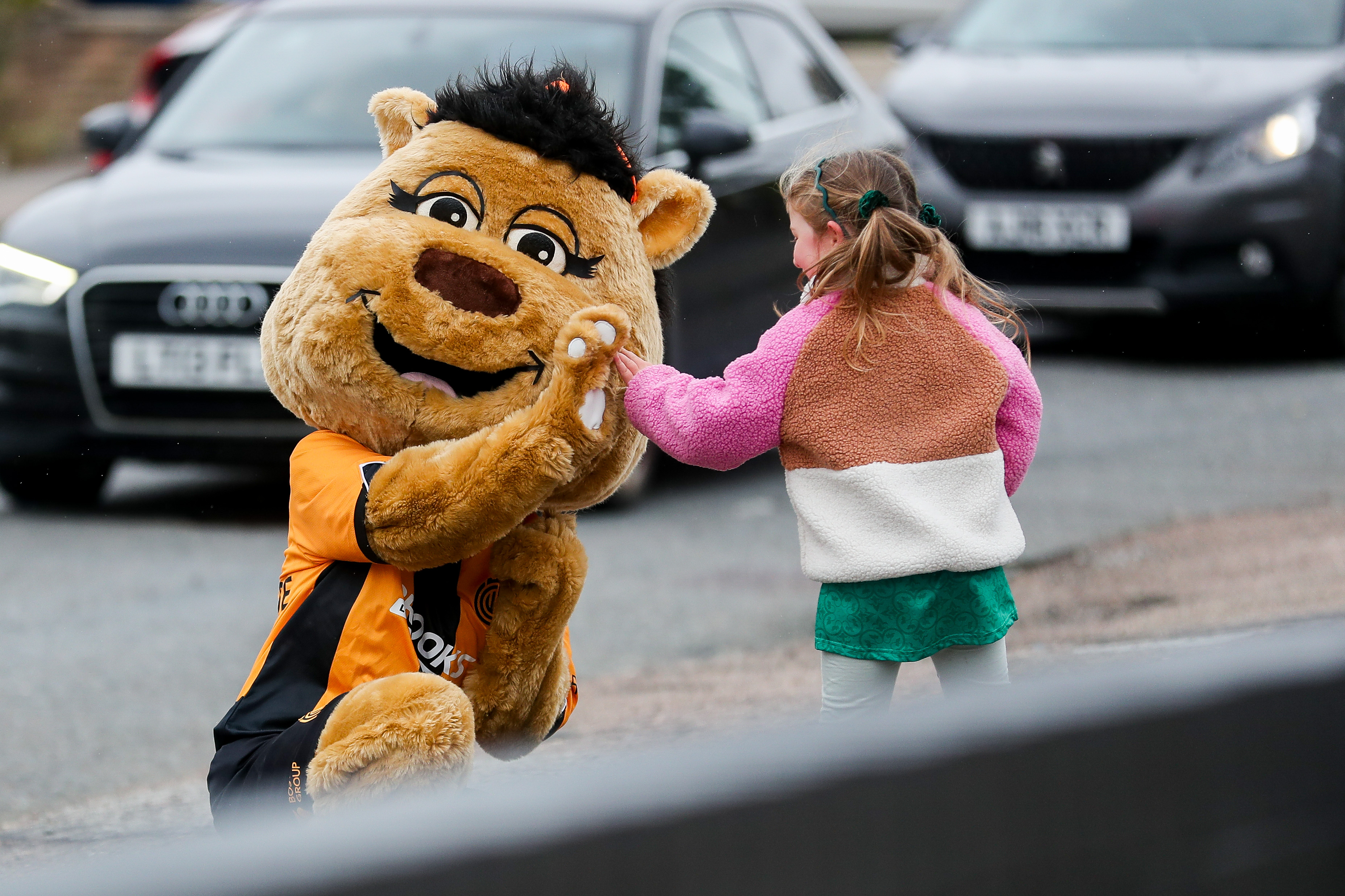 Amber the Moose high fives a fan