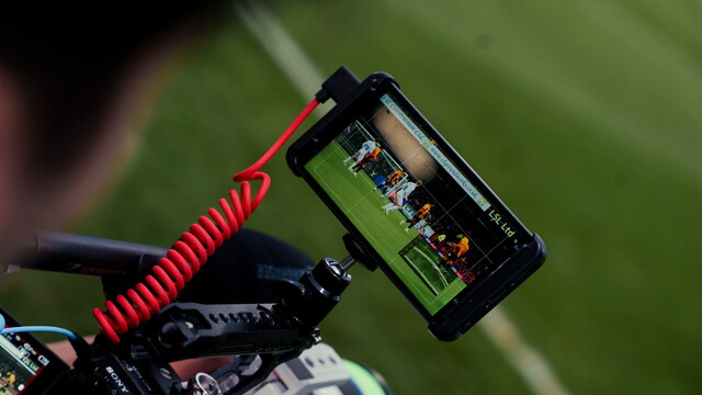A close up of a camera filming a match