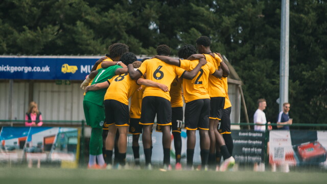Academy players in a huddle