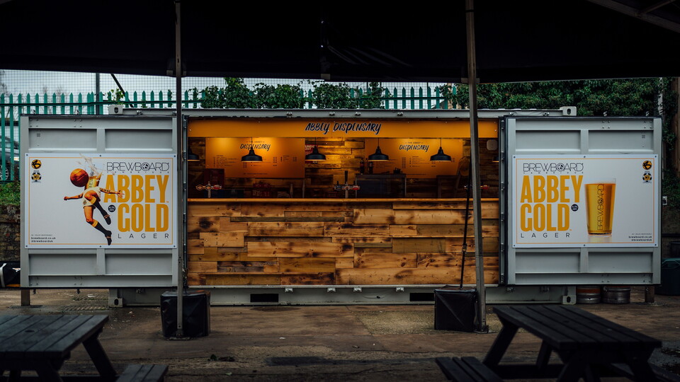 Abbey Gold branding shown in the NRE Fan Zone