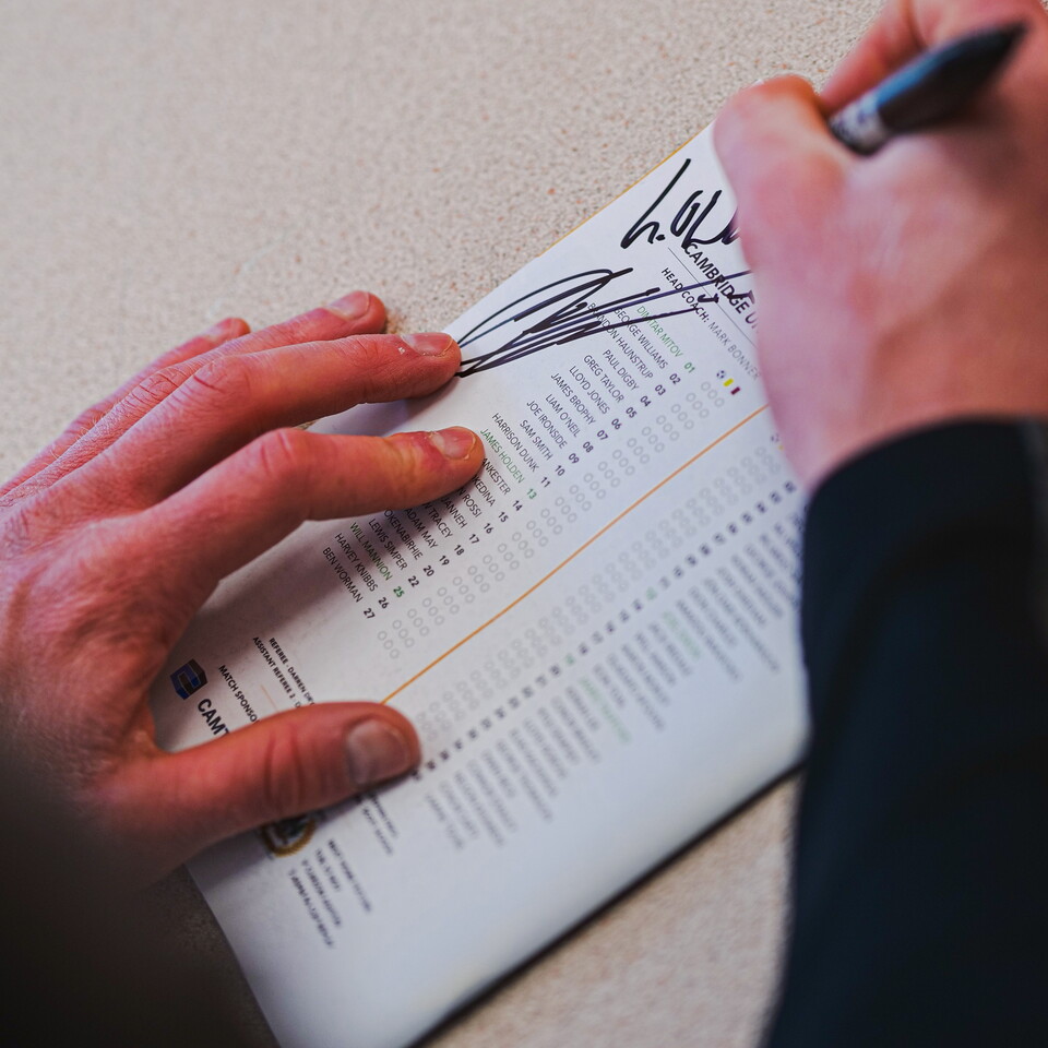 A player signs a child's programme