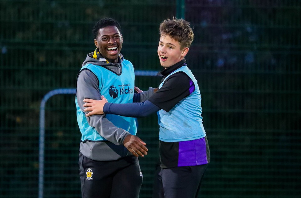 Sullay Kaikai takes part in a Premier League kicks session with a young participant