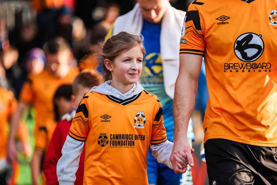 A young mascot walks out