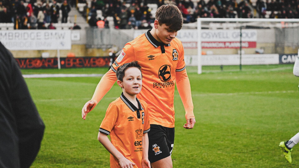 A mascot walks out with Josh Stokes