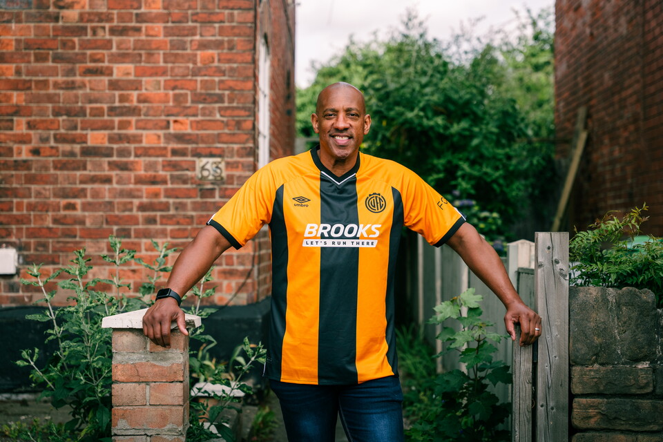 Dion Dublin wearing the 25/26 shirt