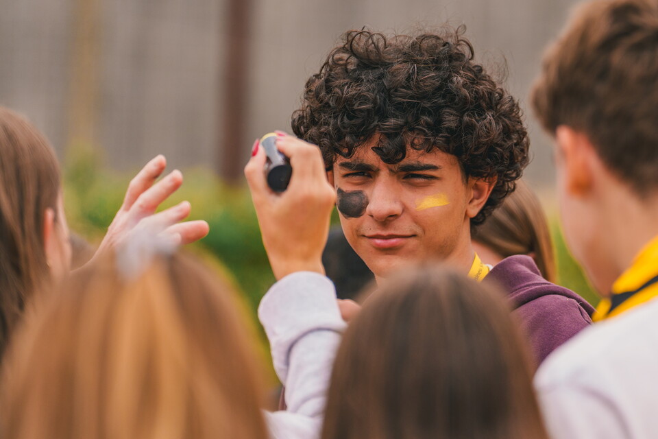 A fan gets face painted at the Cledara Abbey Stadium