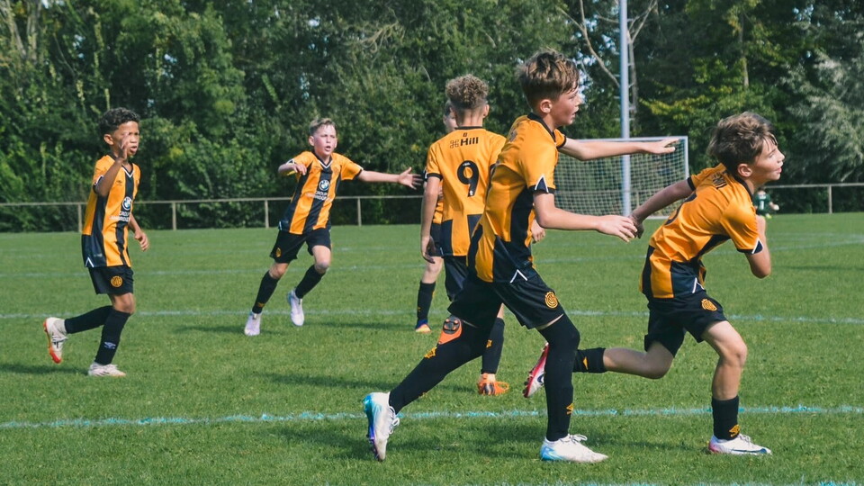 Academy players celebrate