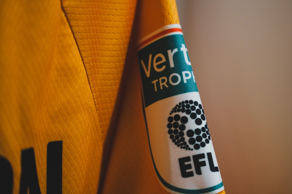 A close up of the Vertu Trophy patch on a shirt