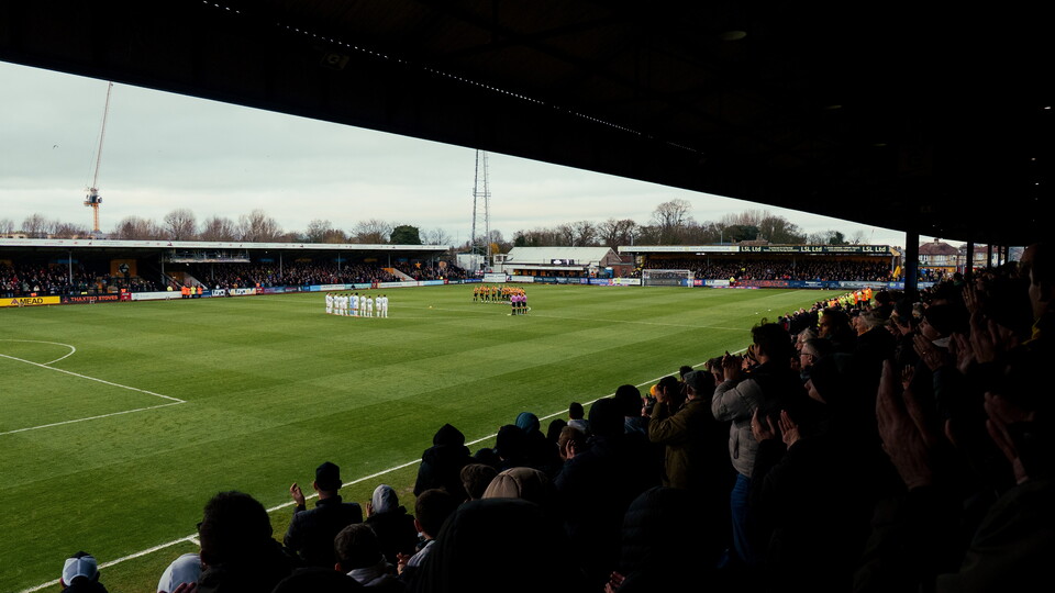 Fans and players gather for a minute's applause