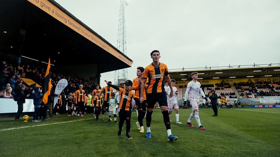 Kell Watts walks out with a Mascot