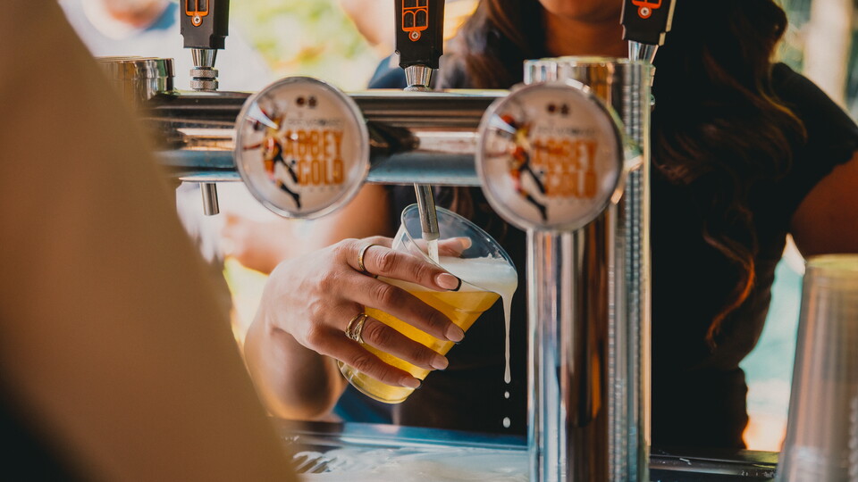 A close up of a Brewboard Beer being poured