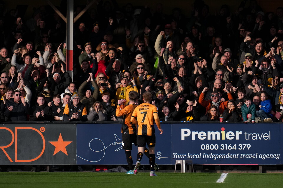 Players celebrate in front of the NRE