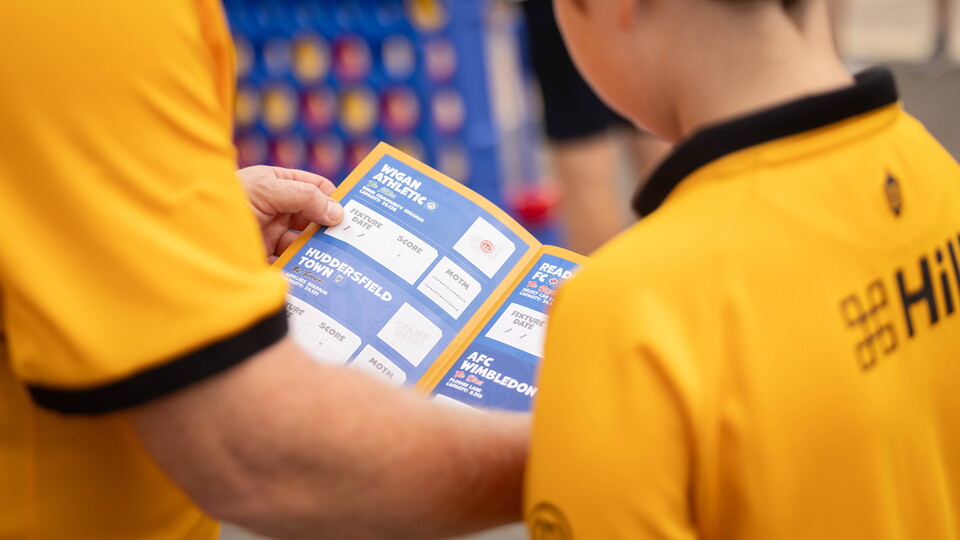 Fans hold a Junior U's Passport