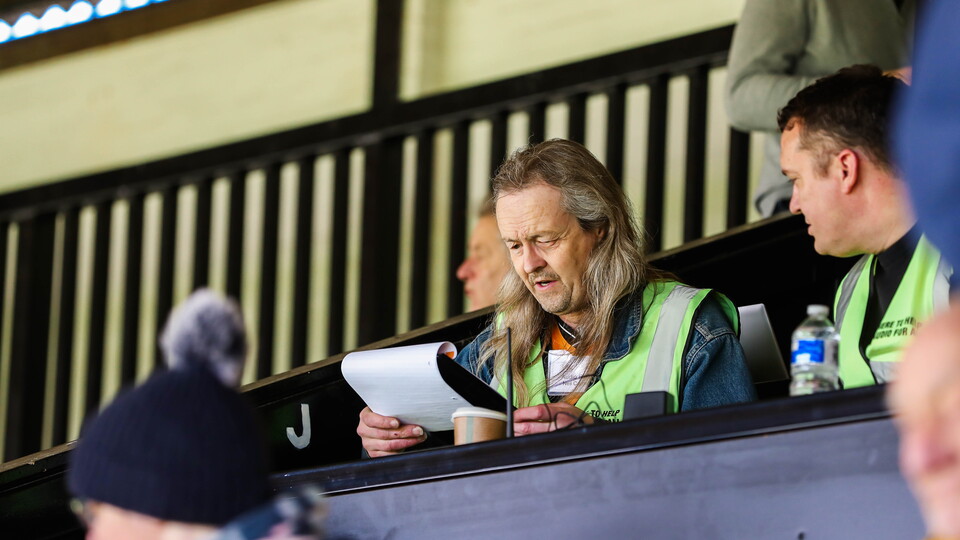 The Club's Audio for All Commentator reads up on his notes
