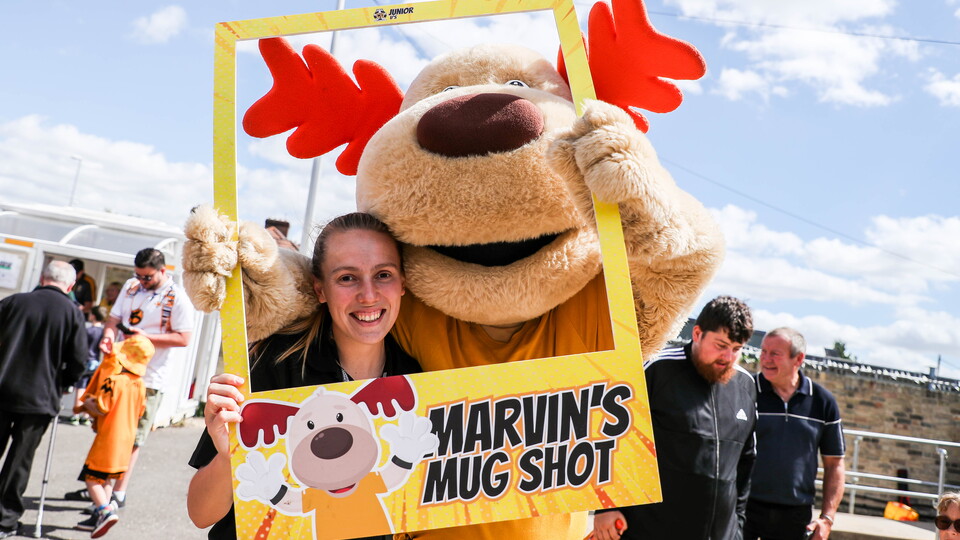 Marvin the Moose poses for the camera with a member of staff