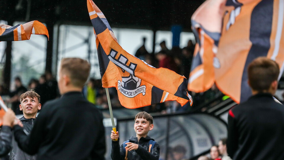 A young fan waves his flag ahead of kick-off