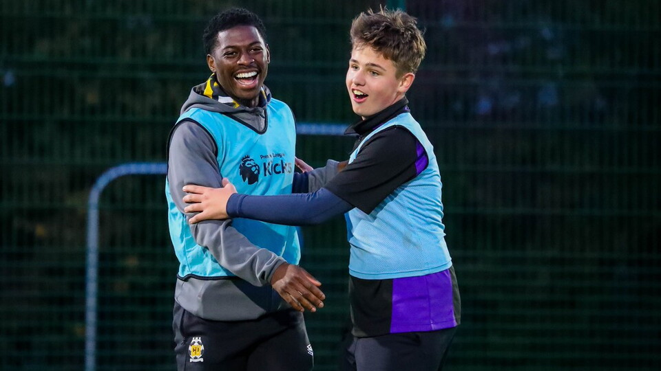 Sullay Kaikai takes part in a Premier League kicks session with a young participant