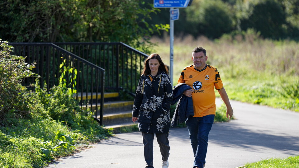 Supporters walk to the Cledara Abbey Stadium