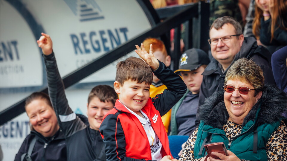 A young fan holds his hand up in a Q&A session