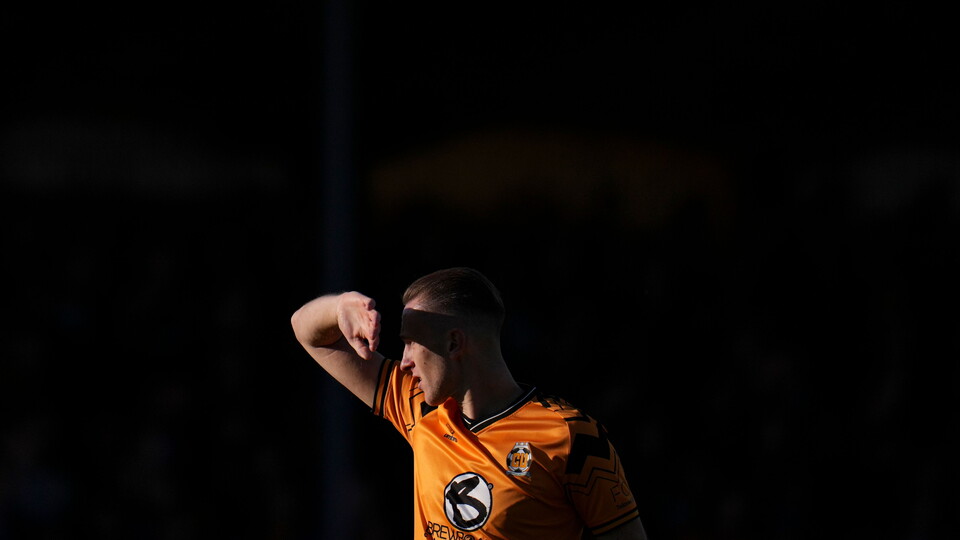 Adam May shields his eyes from the sun