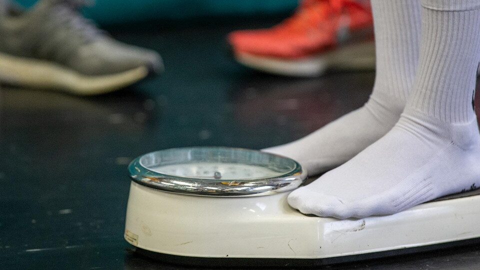 A close up of a player being weighed