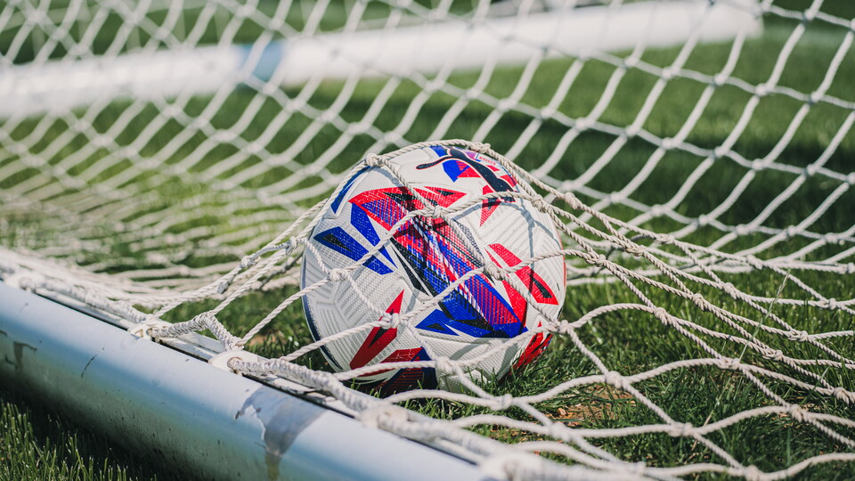 A close-up of a ball in the goal