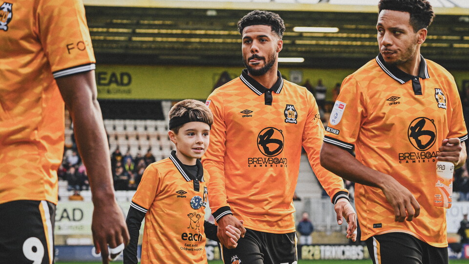 Mascot walks out with Elias Kachunga