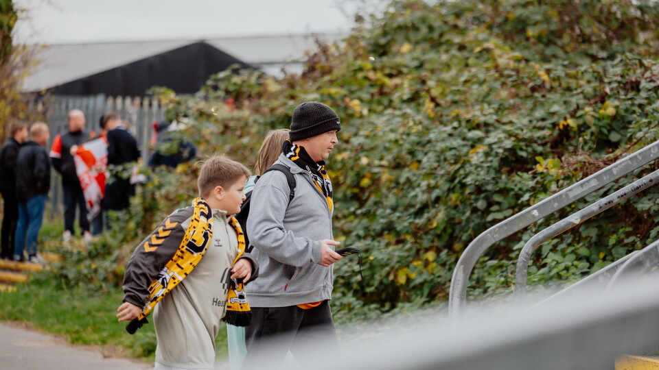 A father and son walk up to the Cledara Abbey Stadium