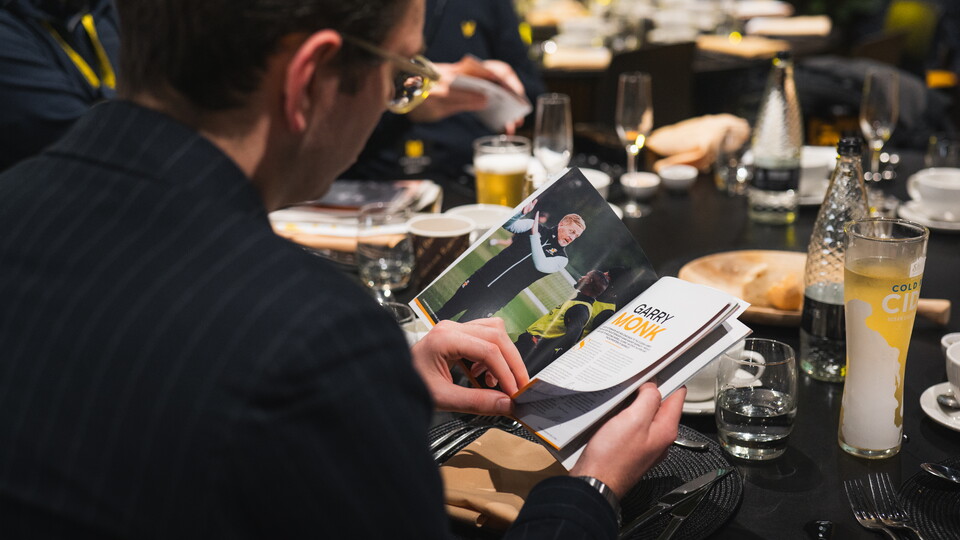 A supporter reading the Matchday Programme