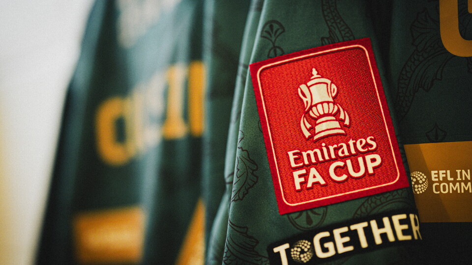 A close up of the Emirates FA Cup badge on a Cambridge United shirt