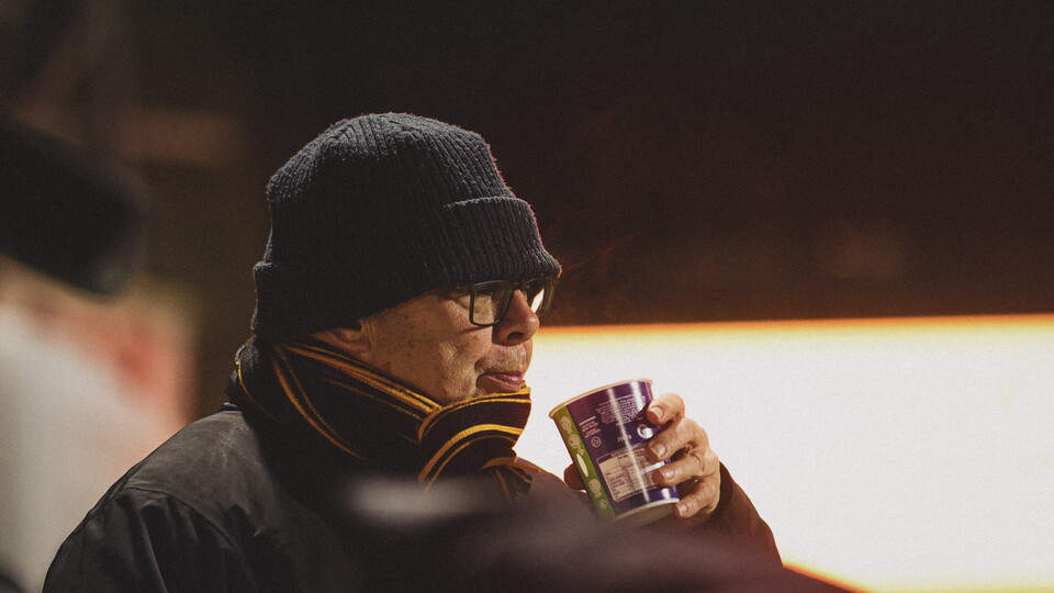 A Cambridge United supporter at an evening game