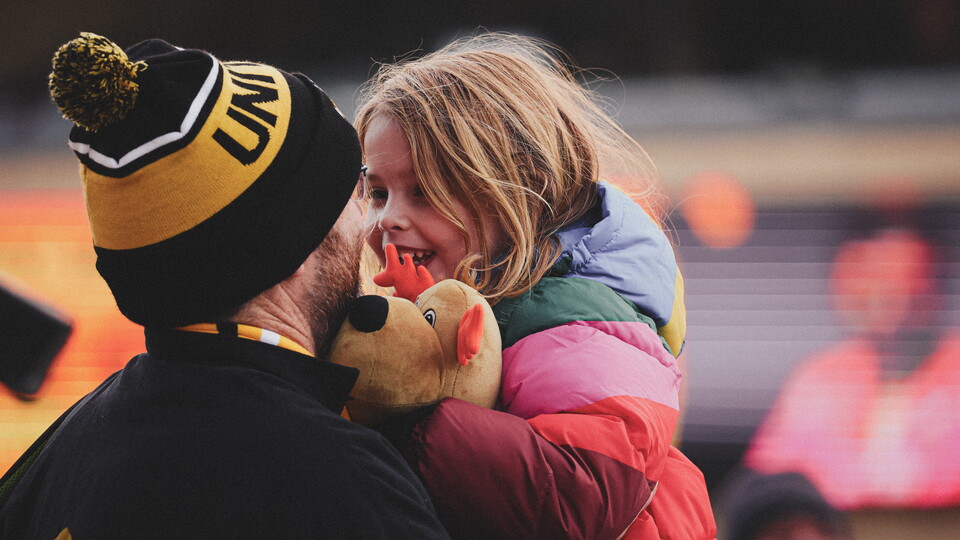 A father and daughter at the game