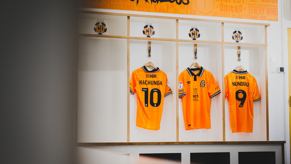 EACH shirts hanging in the dressing room