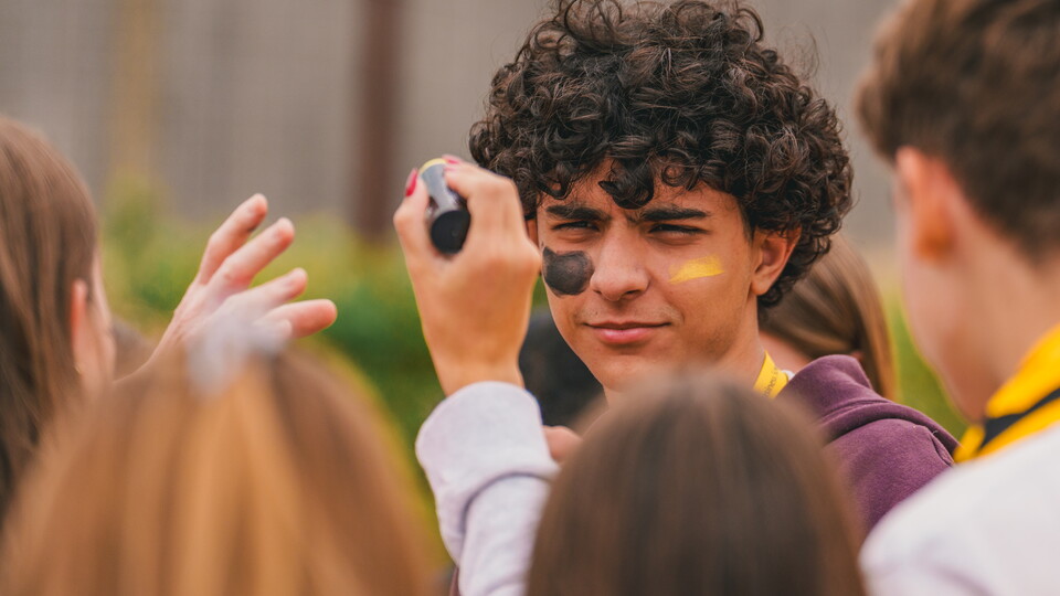 A fan gets face painted at the Cledara Abbey Stadium