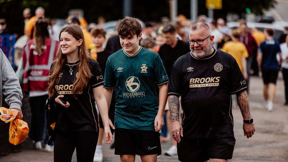 Fans walking to the Cledara Abbey Stadium